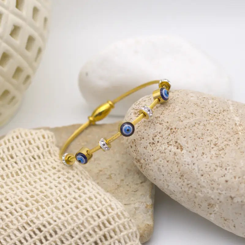 Bracelet jonc doré serti de breloque en forme d'oeil et Zircons