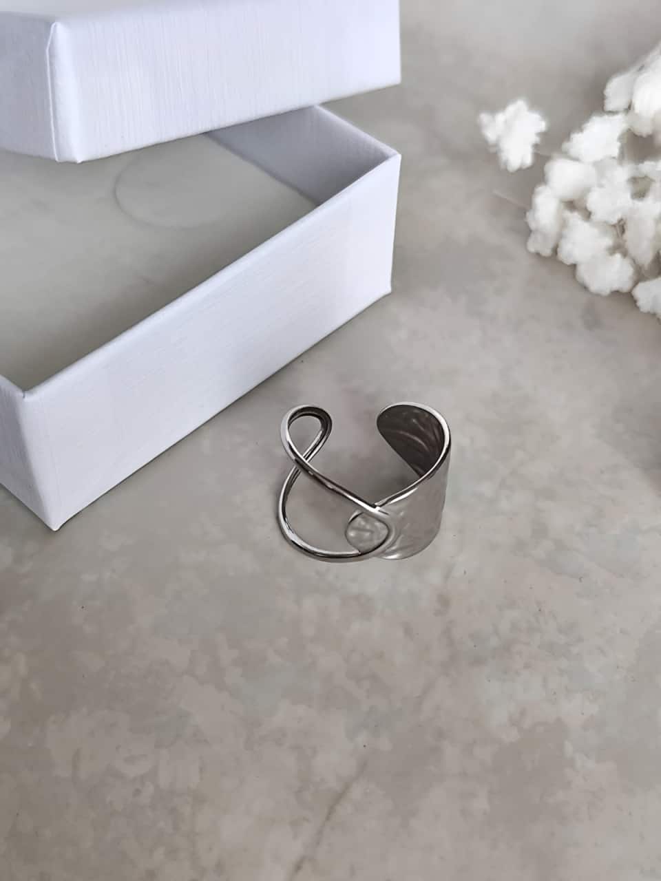 Bague en acier inoxydable argenté, ajourée d'un coté et martelée de l'autre vue d'en haut