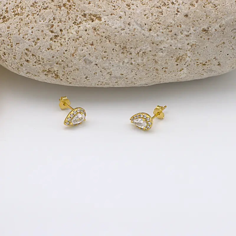 Puces d'oreilles gouttes serties de Zircons en acier inoxydable portées en accumulation sur une oreille en acier inoxydable